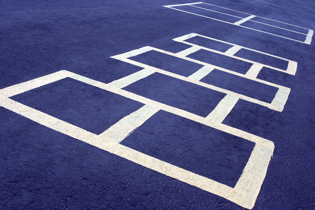 rubberized playground surface with hopscotch pattern in contrasting color